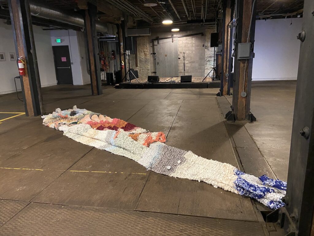 Large pile of fabric in large industrial room.