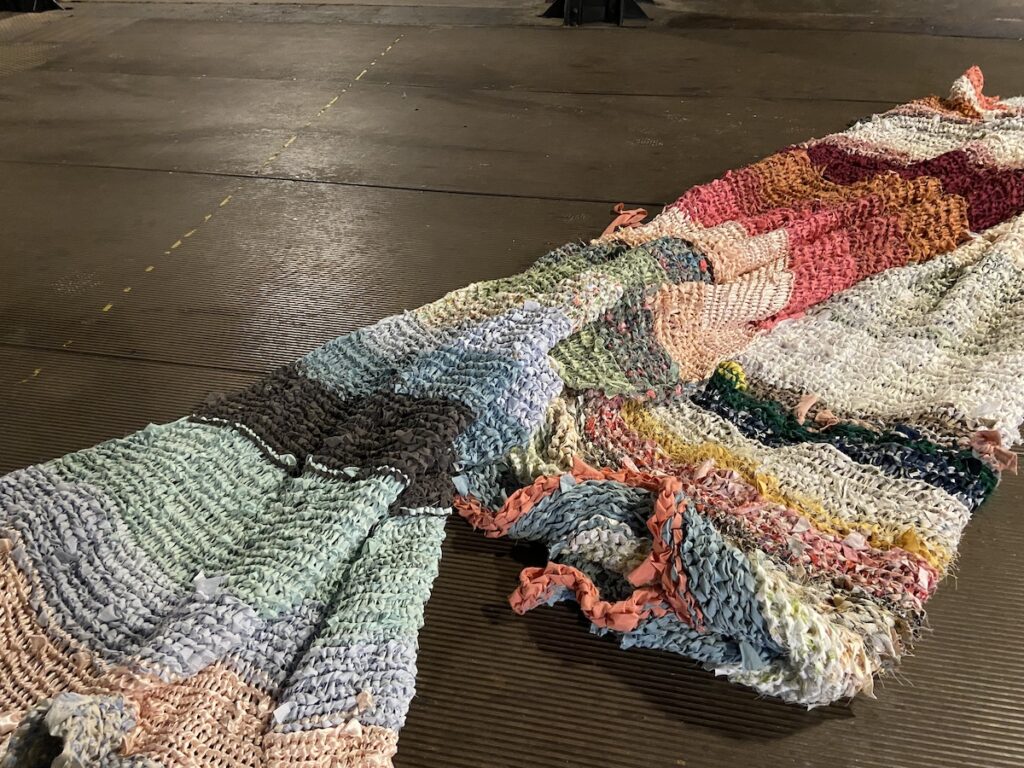 Large pile of fabric in large industrial room.