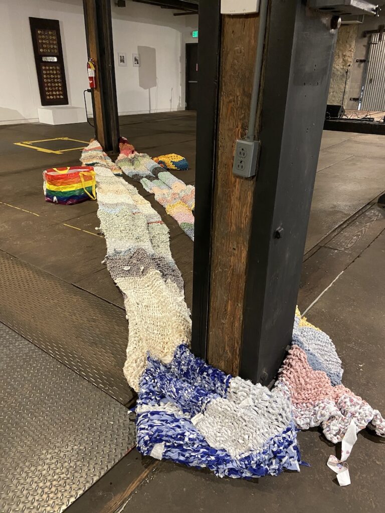 Large pile of fabric in large industrial room.