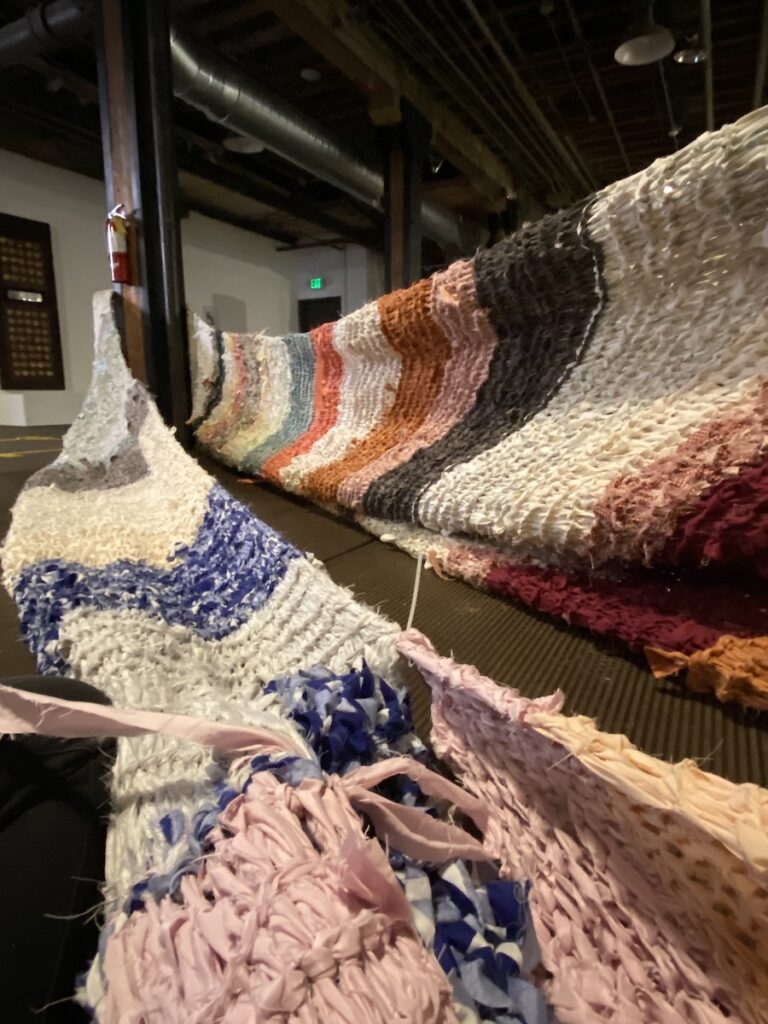 Looking up from the floor at a stretched fabric form.
