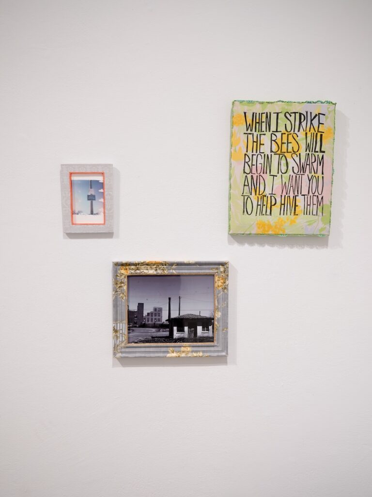 Three artworks hang on a wall.